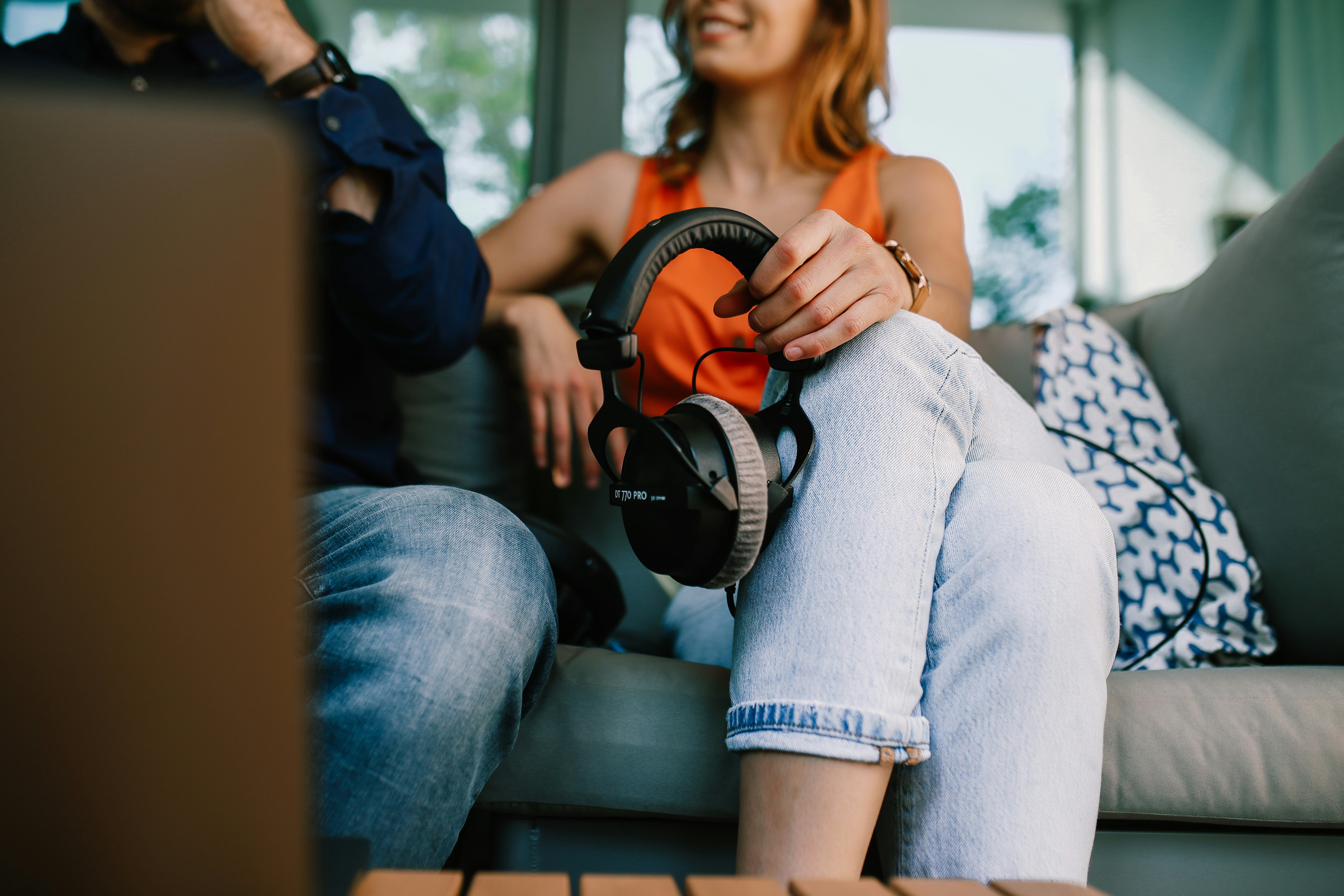 woman in blue denim jeans sitting on black bench